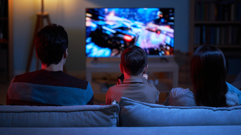 A family playing a game on a TV