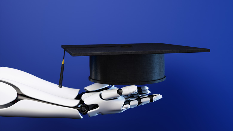 Side View Of Robot Hand Holding Graduation Cap