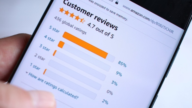 A person looking at Amazon customer reviews on their cellphone