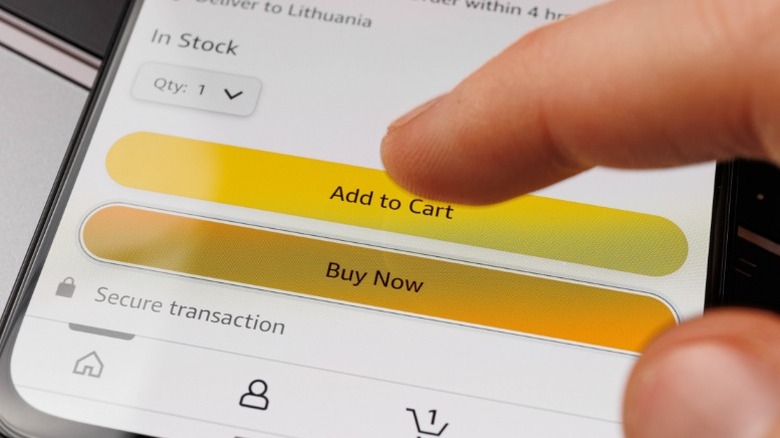 a person tapping the add to cart button on the amazon mobile app