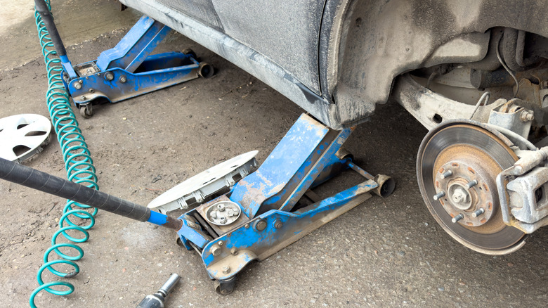 Two old jacks under a car