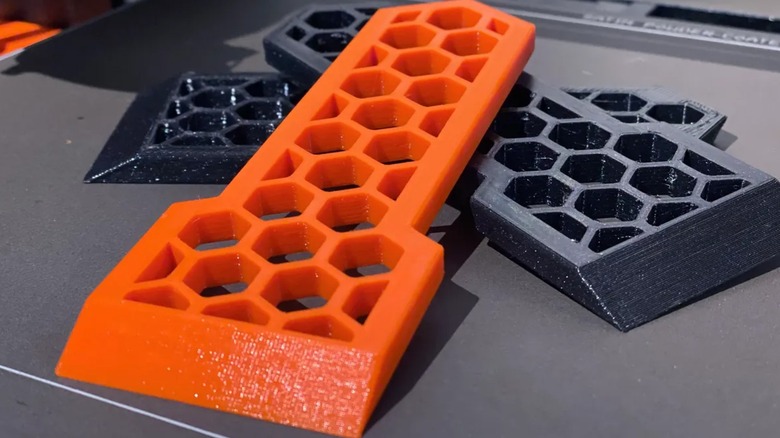 Several scrapers piled on a 3D printer plate.