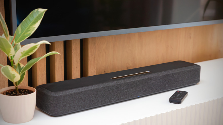 Soundbar below tv on stand