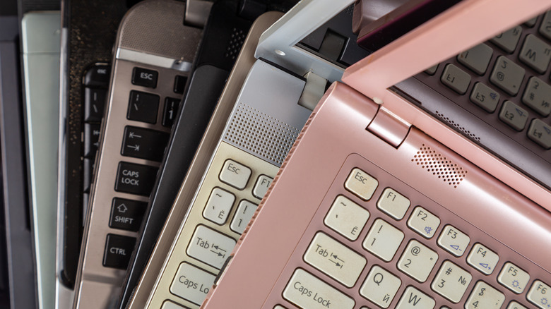 A stack of used laptops fanning out