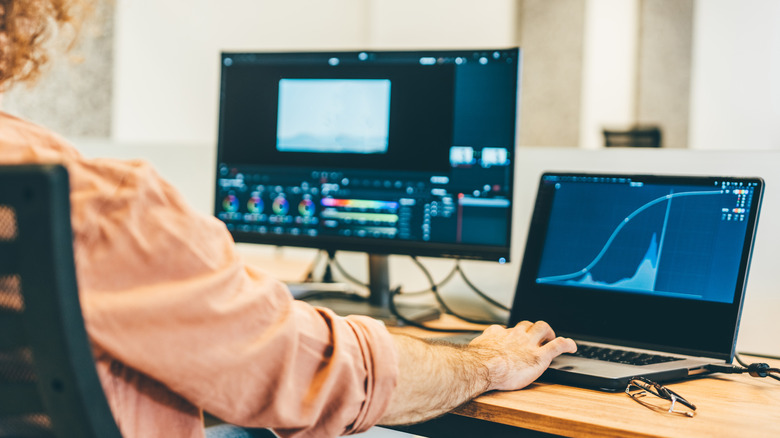 Person at desk editing video footage