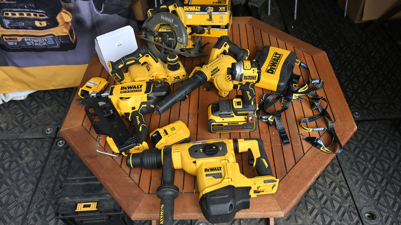 Various DeWalt power tools on a wooden table