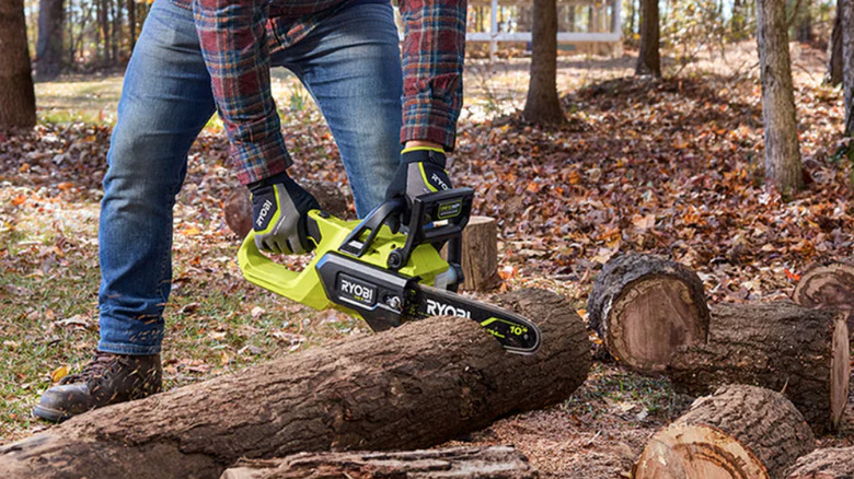 Ryobi's new brushless 10-in. chainsaw being used by man
