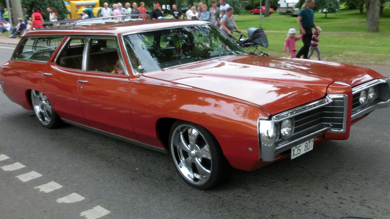 A burnt-orange 1968 Pontiac Executive Safari wagon on park roadway