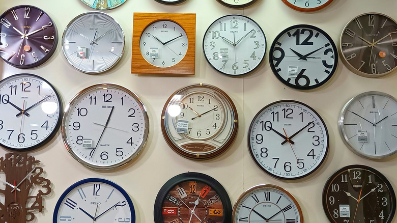 Group of analog wall clocks on one wall