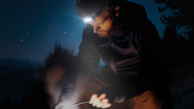 Man using Nitecore headlamp while in the outdoors