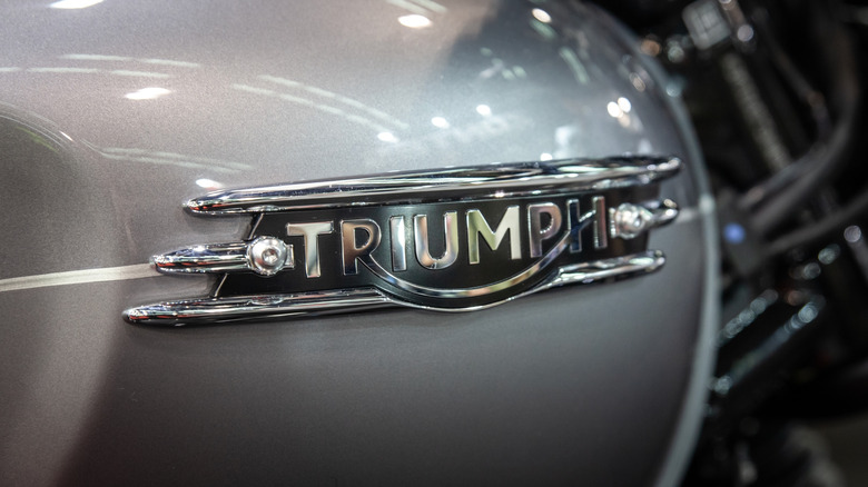 Close-up of the logo on a Triumph motorcycle.