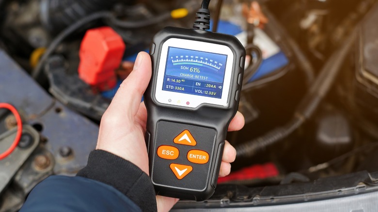 a person using a car battery tester