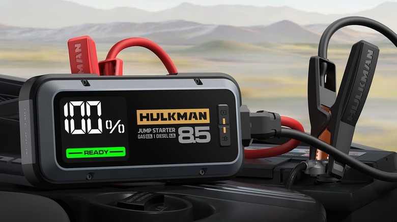 Hulkman Alpha 85 jump starter attached to car battery