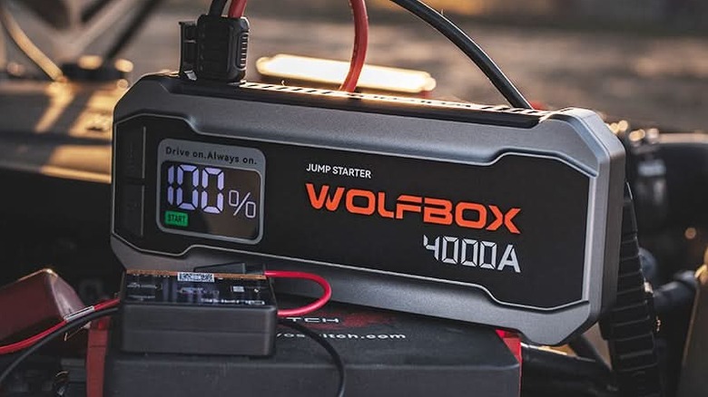 Wolfbox MV24 jump starter attached to car battery