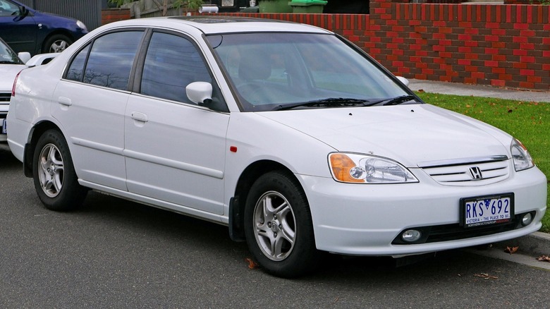 White 2002 Honda Civic parked by the roadside with other cars in the background