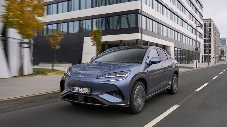 2025 BYD Sealion 7 driving on city road, front-left view