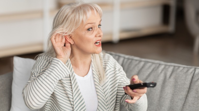 Woman finding it difficult to hear TV audio