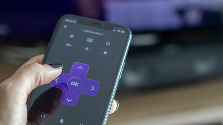 Person using phone as Roku TV remote