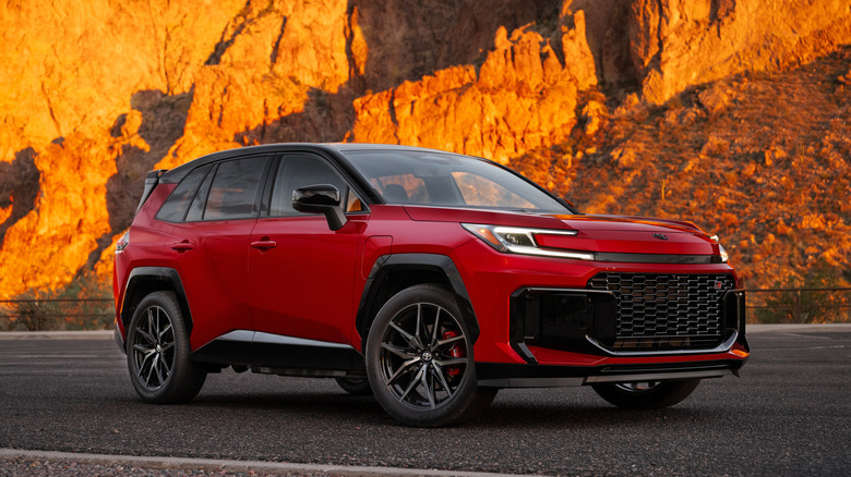 A red 2026 Toyota RAV4 PHEV GR Sport parked on a mountain road.