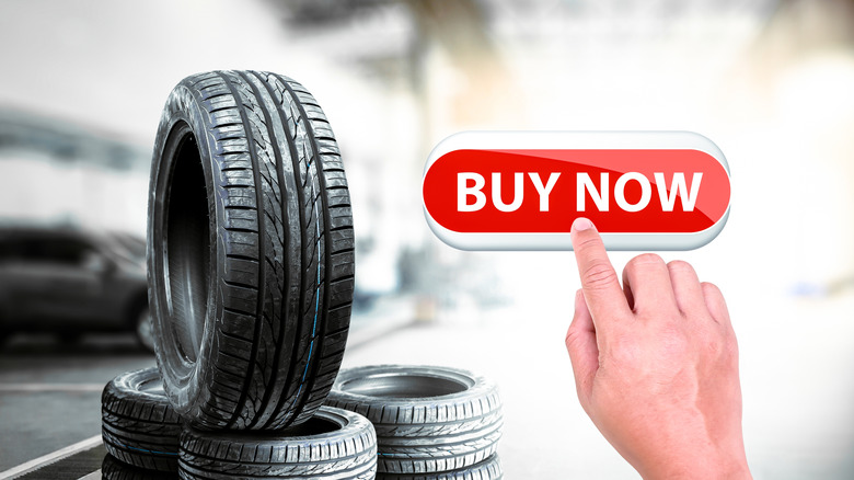 Car tire shop business concept , Hand is pressing red button to buy car tires