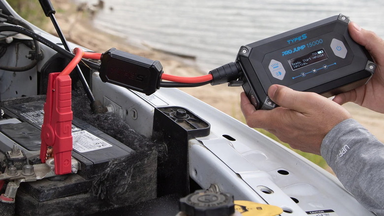 person using a Type S 15000mAh ProJump Starter on a truck