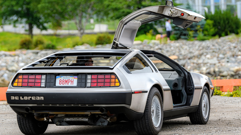 Rear view of a DeLorean DMC-12 parked with right door open