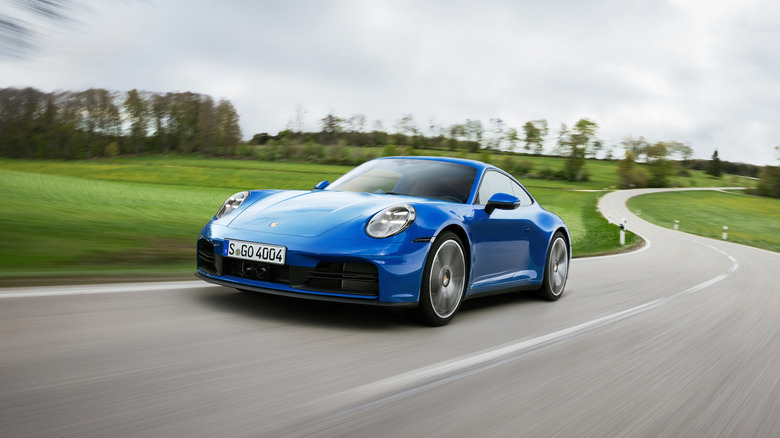 A blue 2025 Porsche 911 driving