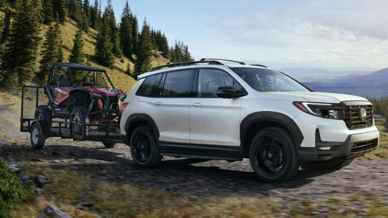 White 2025 Honda Passport Trailsport towing a quad