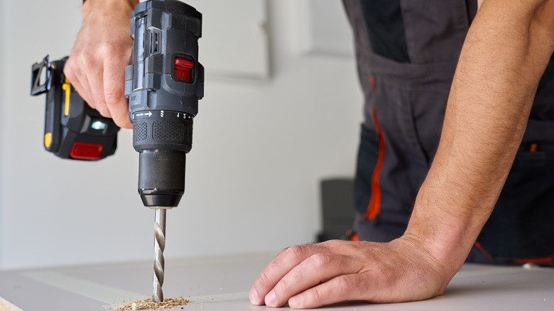 Person drilling table