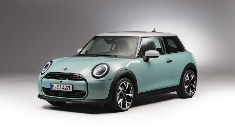 Front 3/4 view of MINI Cooper Hardtop, teal exterior, studio shot