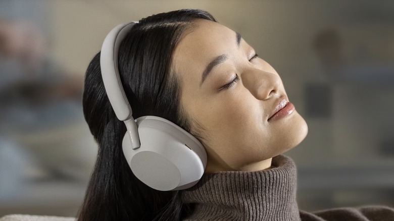 person listening Sony WH-1000XM5 headphones
