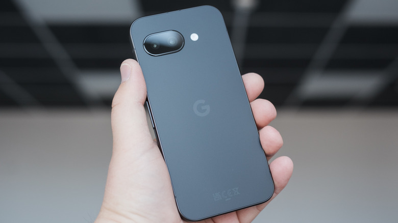 A person holding a Google Pixel 9a in their hand