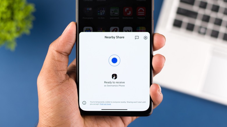 hand holding phone with nearby share