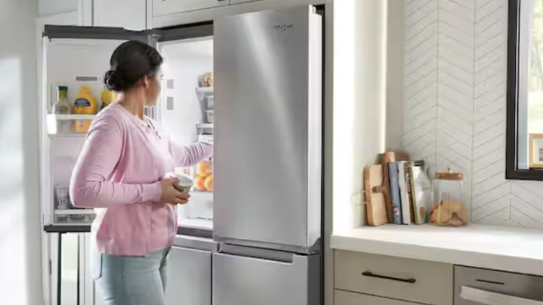 Woman looking in Whirlpool French door refrigerator