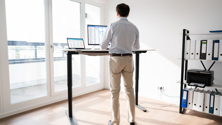 man working at standing desk