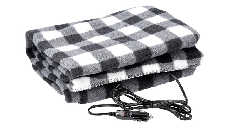 A black and white plaid electric blanket with a car adapter
