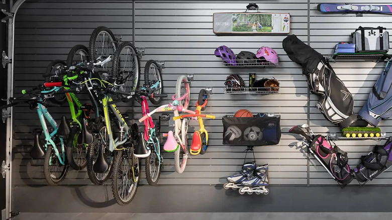 A slatwall panel holding various items in a garage