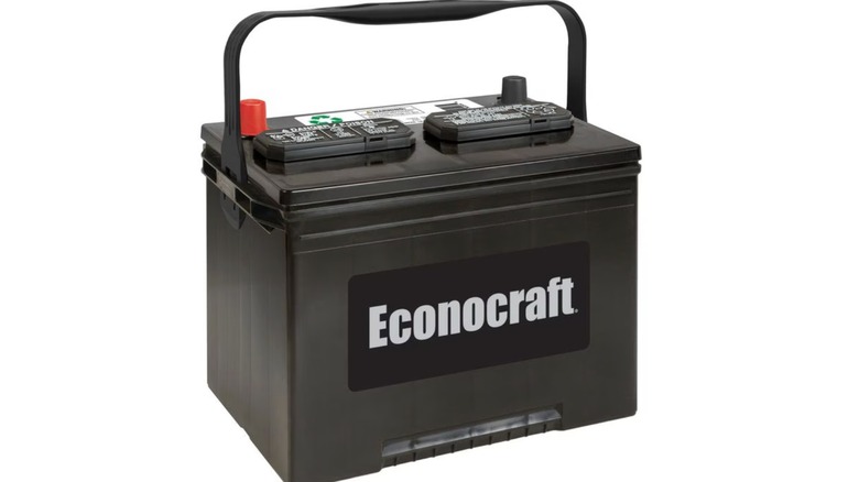A black Econocraft car battery with a carrying handle and labeled top terminals