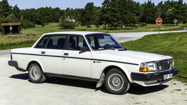 Volvo 240 GL sedan parked on road, front-right 3/4 view
