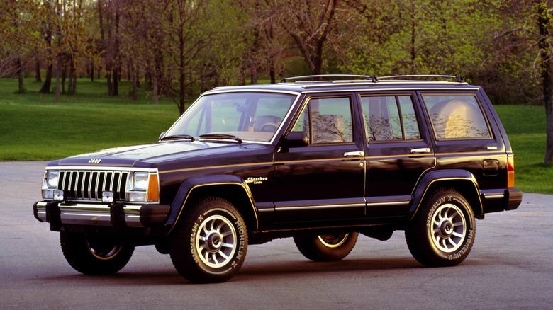 1985 AMC Jeep Cherokee Laredo parked on road, front-left 3/4 view