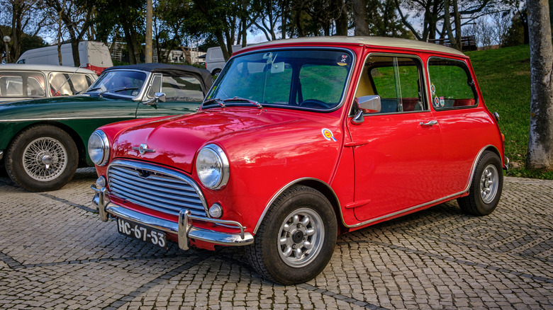 Original red Mini Cooper parked at car show, front-left 3/4 view