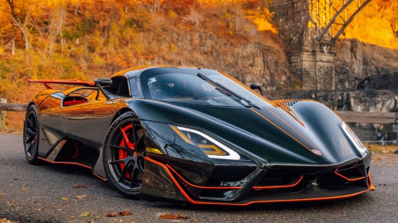 Black SSC Tuatara parked on a road in fall