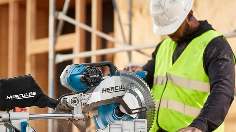 Construction worker using a Hercules 12-inch Dual-Bevel Sliding Compound Miter Saw
