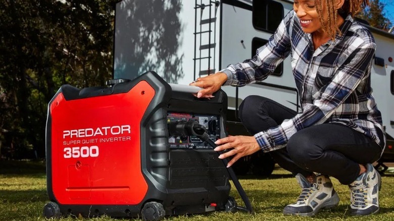 Person operating a Predator 3500 Watt Super Quiet Inverter Generator