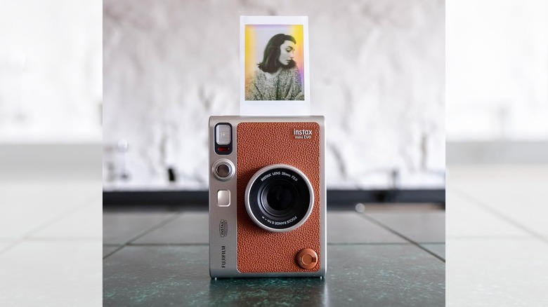 the Fujifilm instax mini Evo on the floor with a printed photo