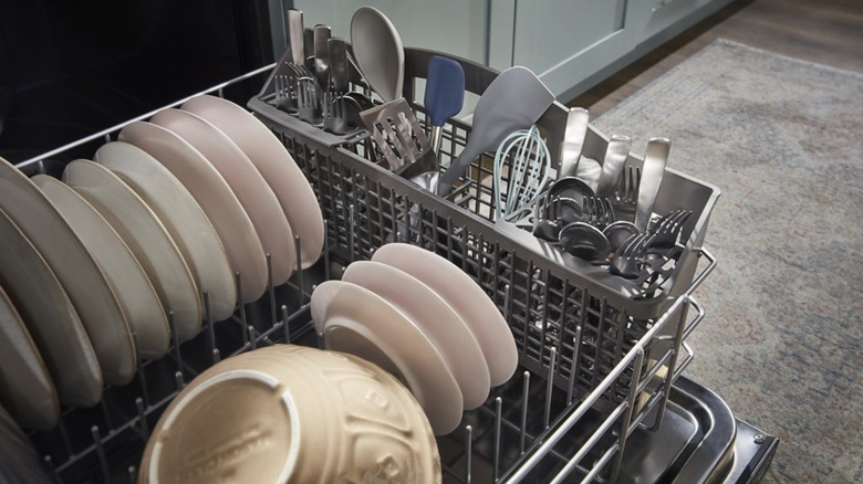 Bottom rack of Whirlpool WDT730HAMZ Eco Series 24-inch Top Control Built-in Dishwasher opened and filled with dishes