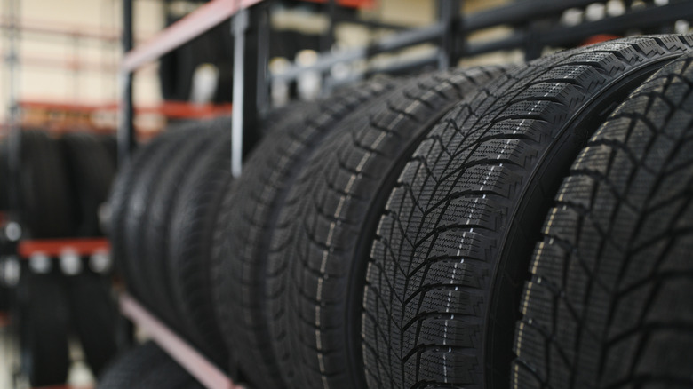Tires placed next to each other on a stand in a shop.