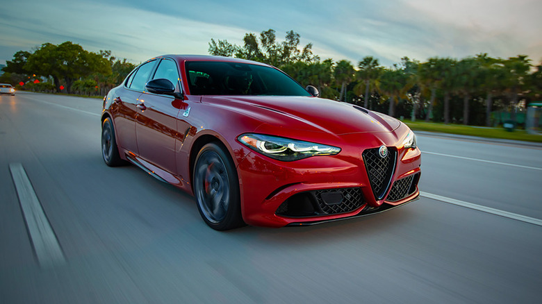 A red 2024 Alfa Romeo Giulia Quadrifoglio driving