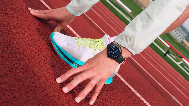 Runner at the starting line on a track, wearing a Pixel 4 smartwatch