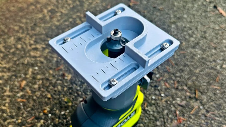 A 3D printed guide connected to a Ryobi router.